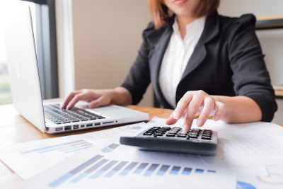woman, calculator, laptop, forms, strategic tax resolution